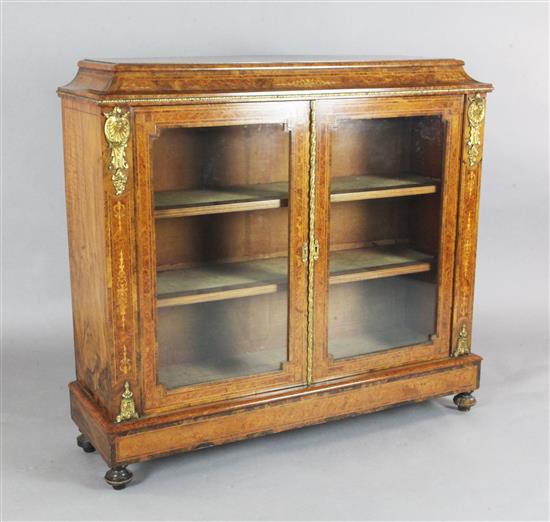 A Victorian marquetry inlaid burr walnut bookcase, W.4ft D.1ft 3in. H.3ft 7.5in.